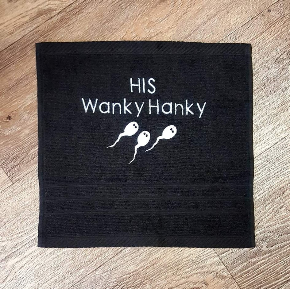 This image shows a personalised gift for him, his wanky hanky. This image is a black cloth with printed text in white. Displayed on the www.the-personalisation-company.co.uk website. Personalised gifts for him.