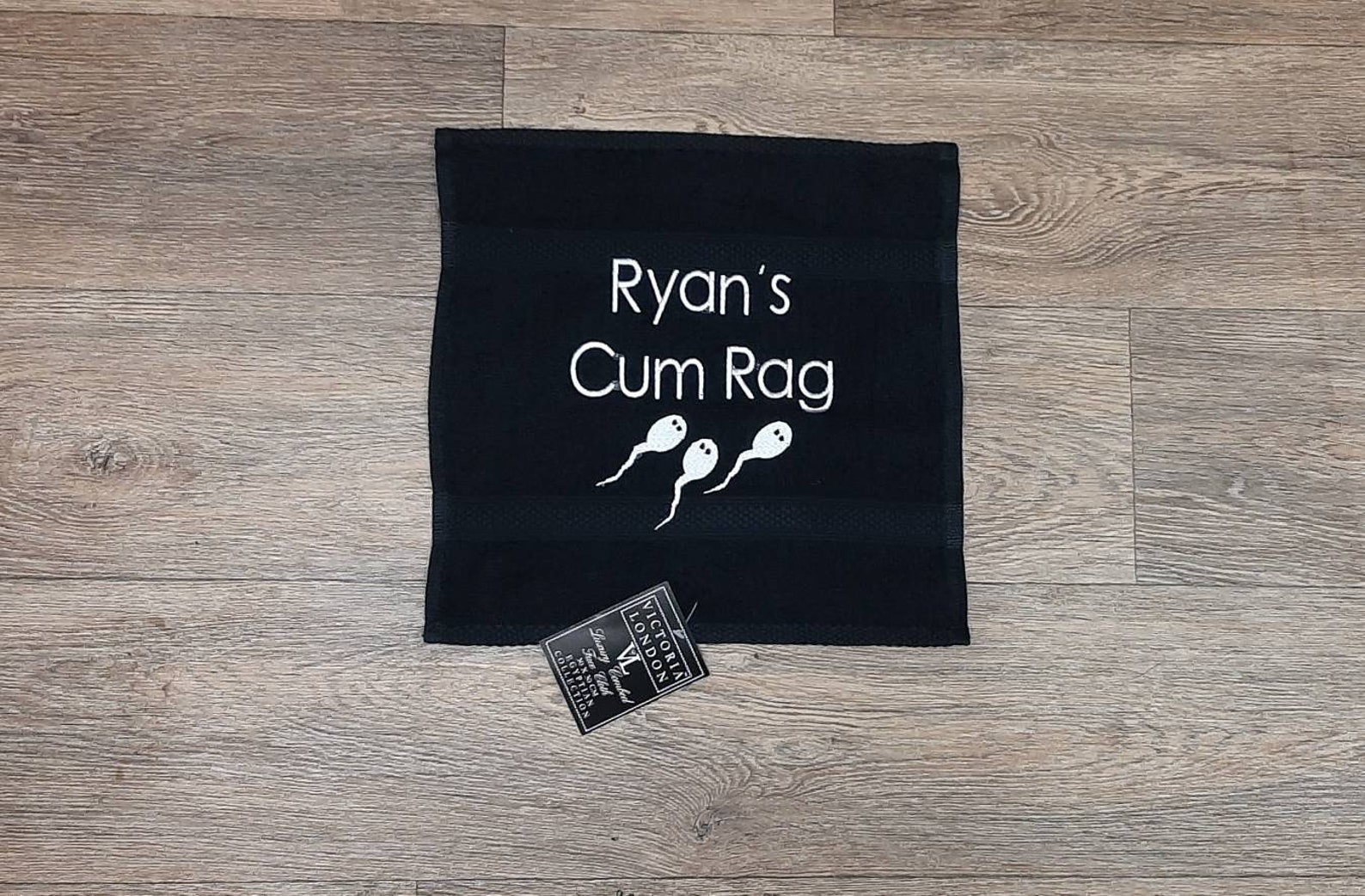 cum rag, fun gift for him.This image shows a personalised gift for him,. This image is a black cloth with printed text in white. Displayed on the www.the-personalisation-company.co.uk website. Personalised gifts for him.