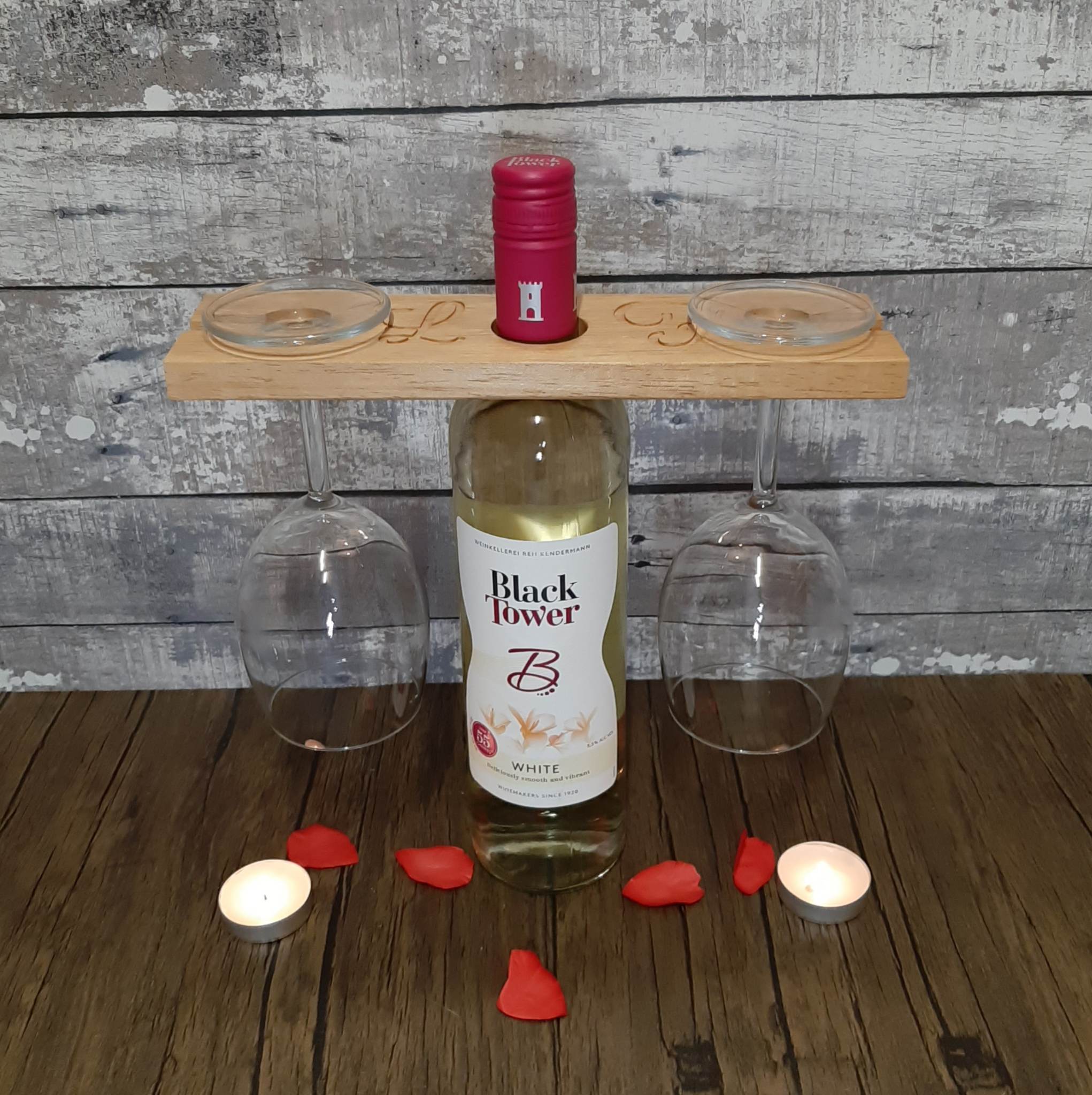 Wooden Wine Glass Holder with cnc engraved initials set up holding the glasses on a bottle of wine