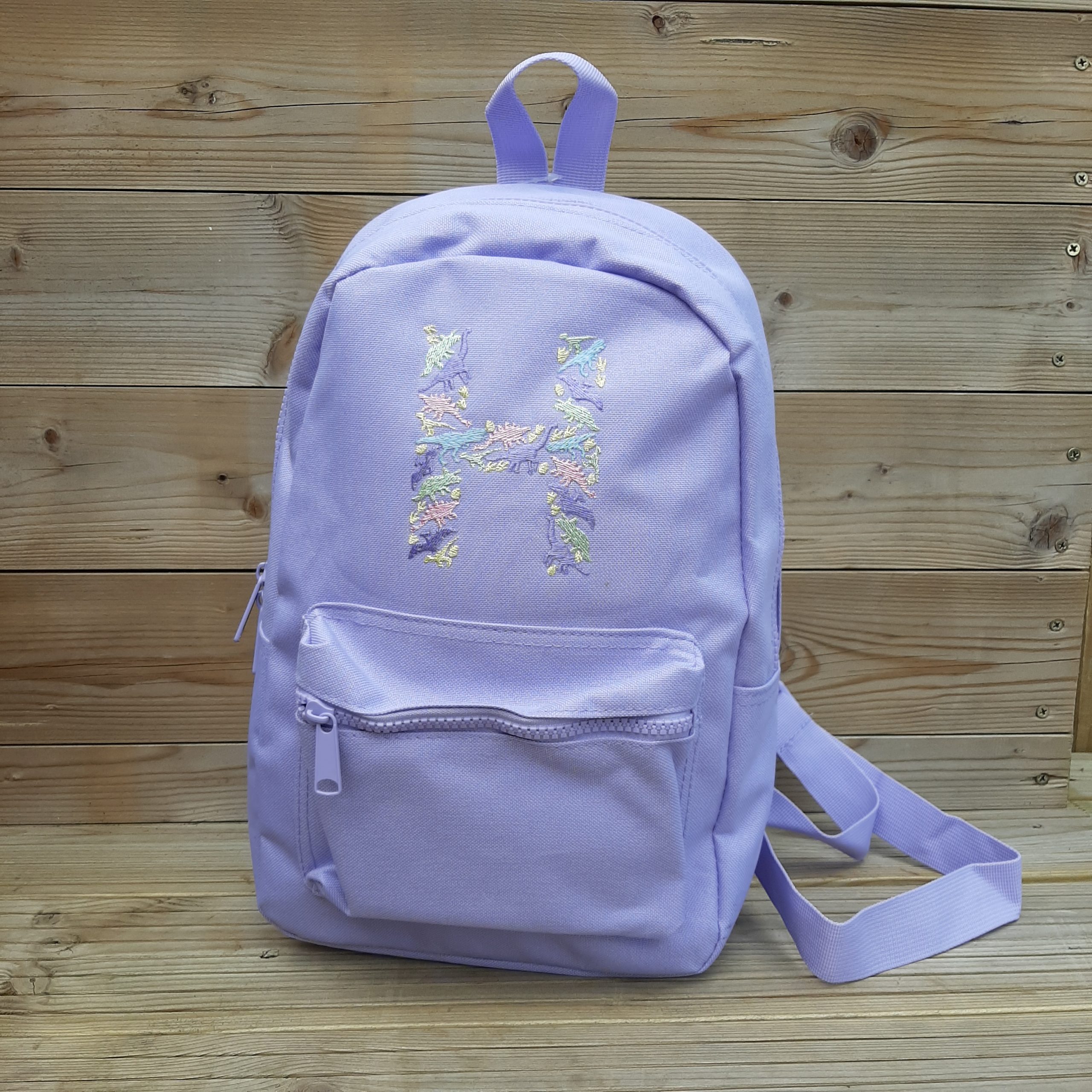 lavender backpack with H embroidered initial in pastel dinosaurs girls bag