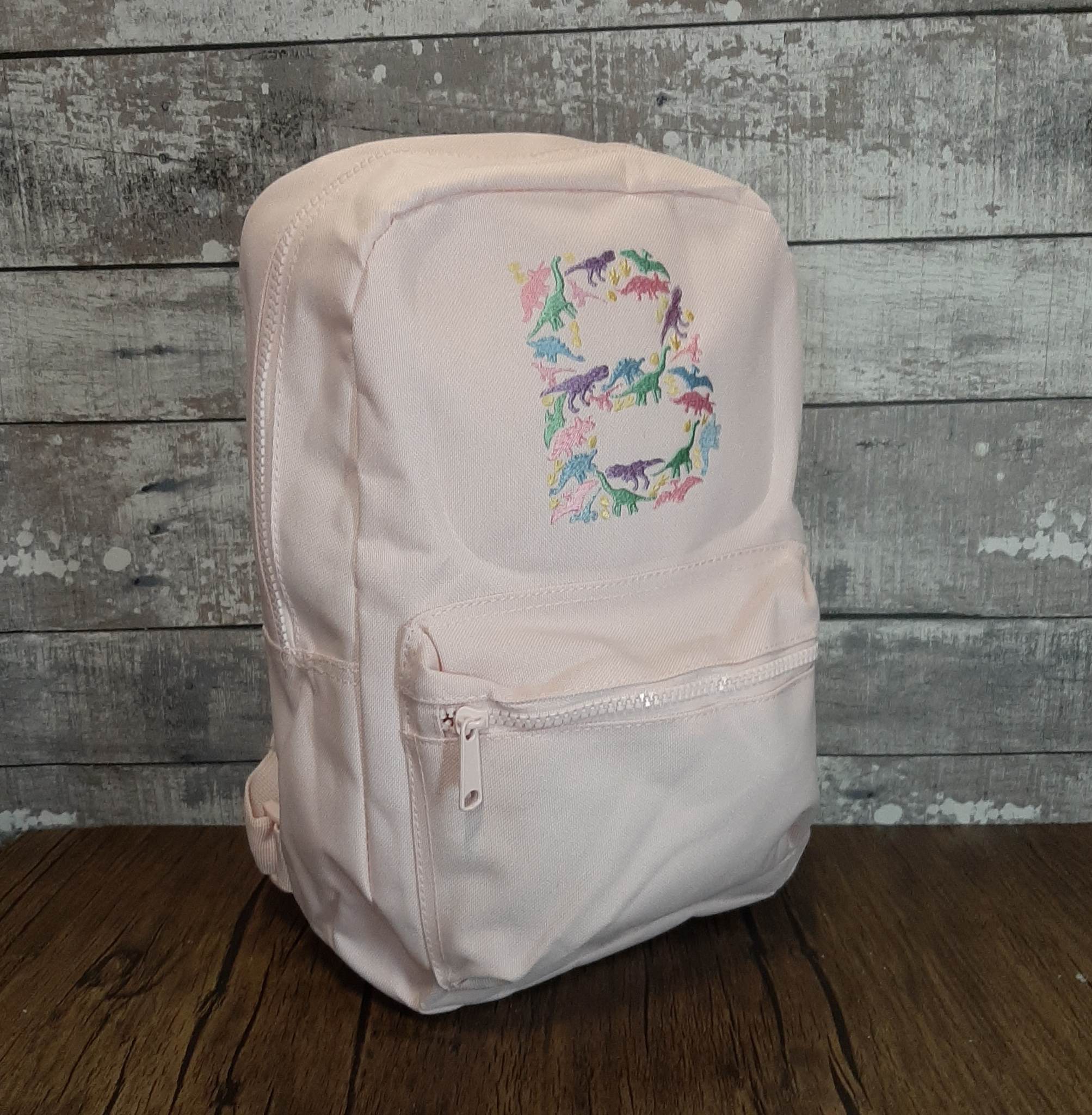 Backpack With Embroidered Initial pink with pastel dinosaur initial