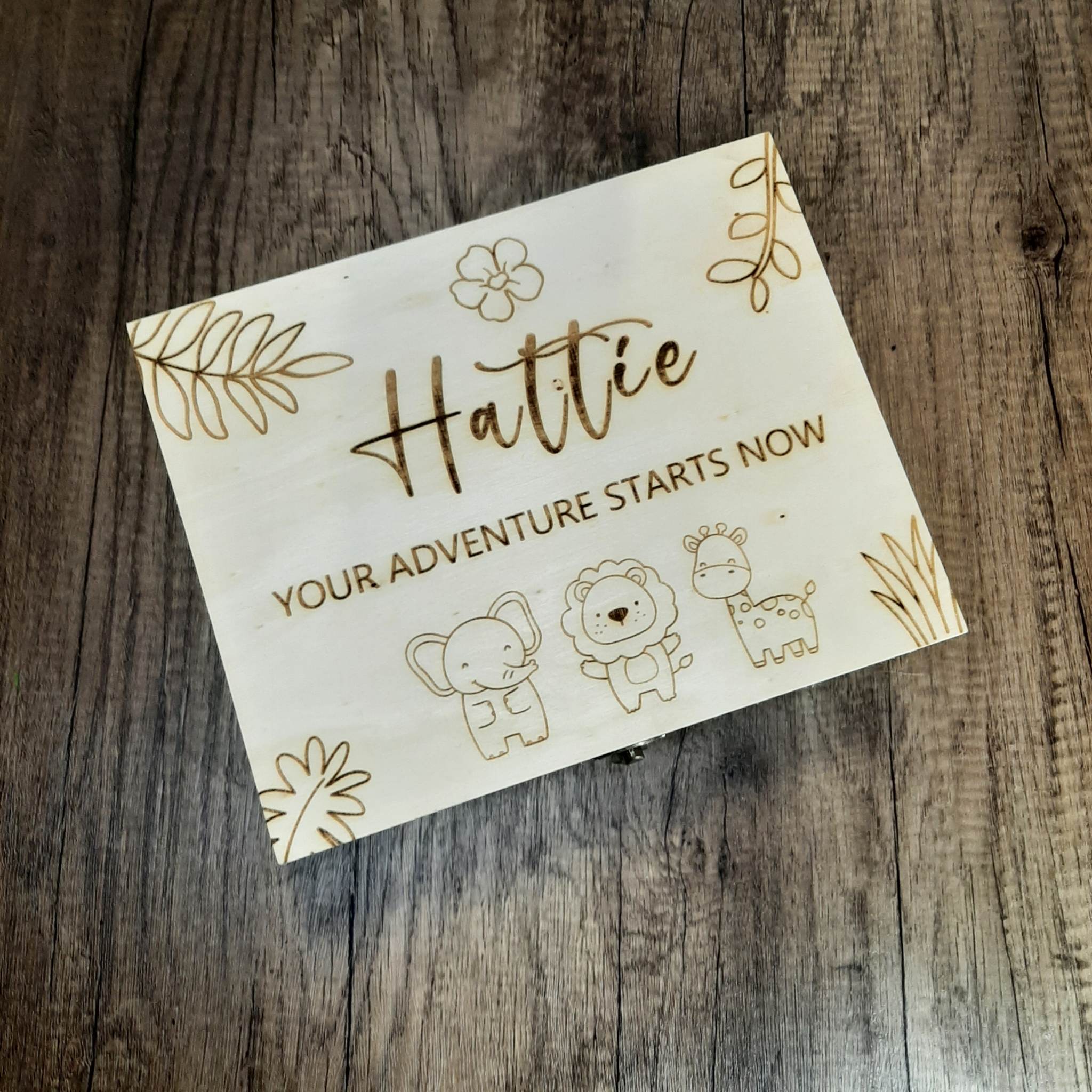 Wooden Baby Keepsake Box on a dark floor, showing personalised name and engraved safari theme