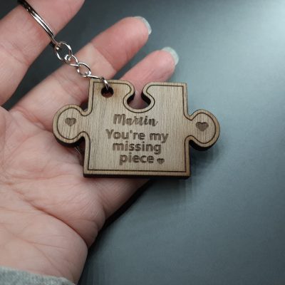 Missing Piece Puzzle Keyring in hand showing size of keyring, laser engraved with you're my missing piece
