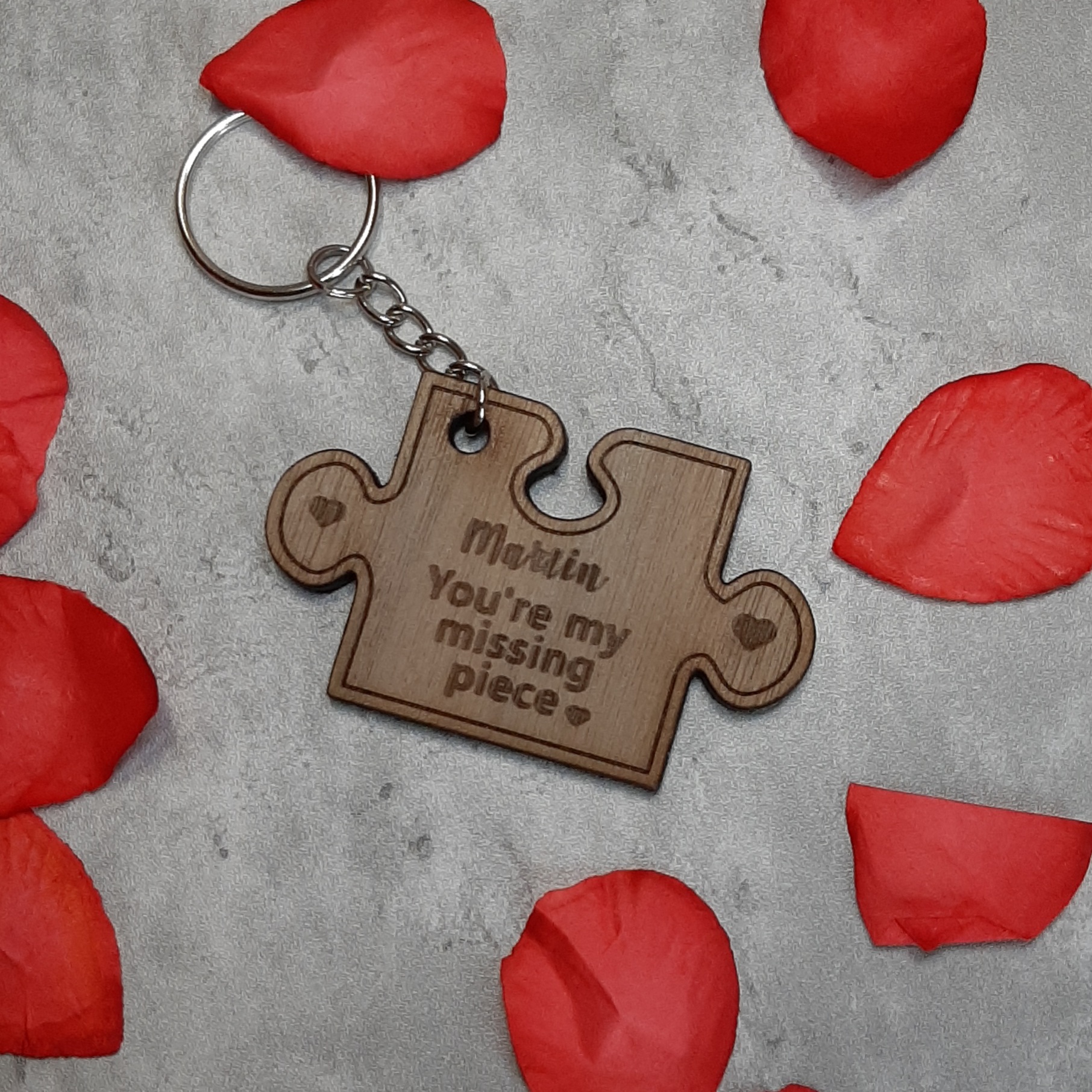 Missing Piece Puzzle Keyring surrounded by rose petals for valentines day, laser engraved with you're my missing piece