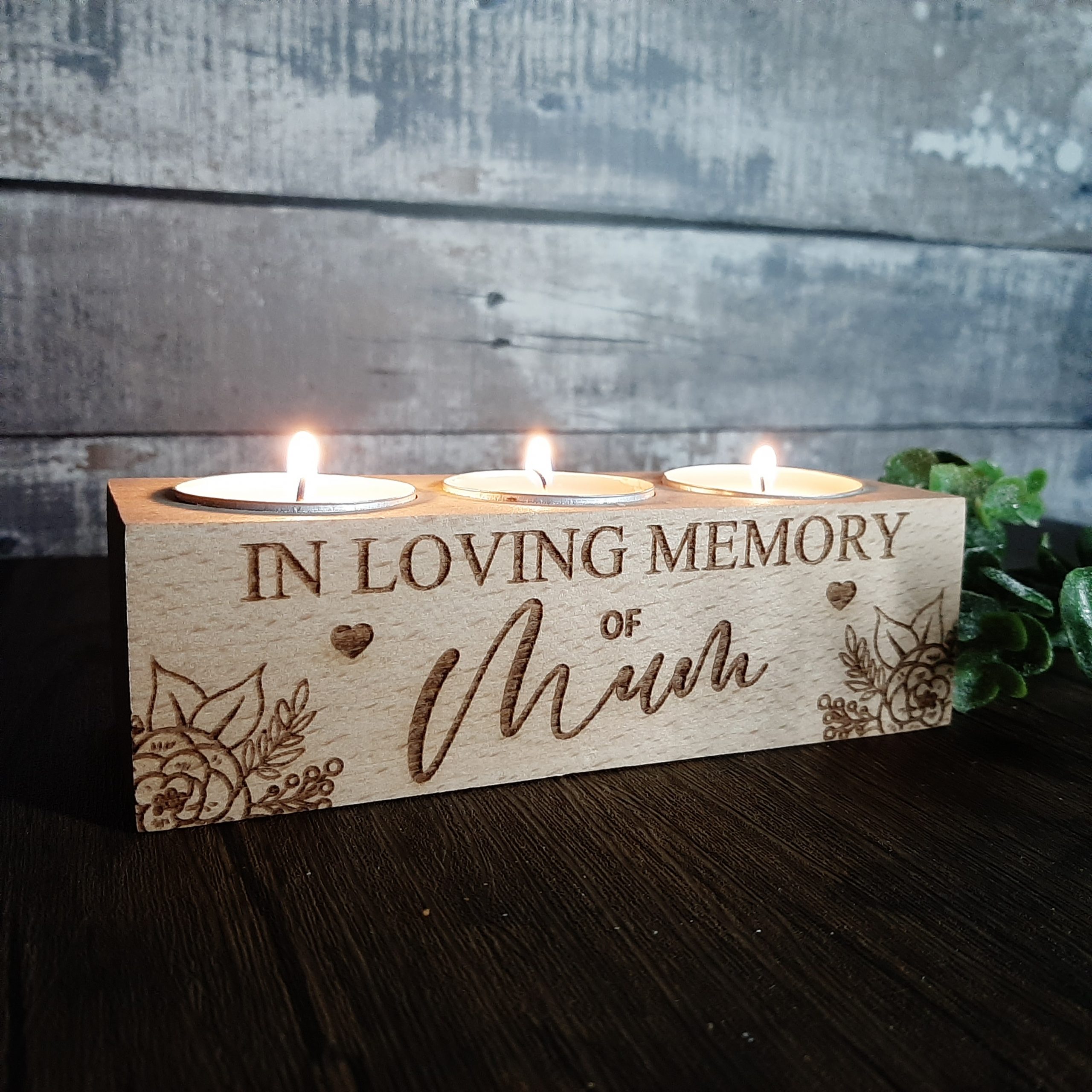 Memorial Tealight Holder with mum personalised on it with flowers in the corner with candles lit
