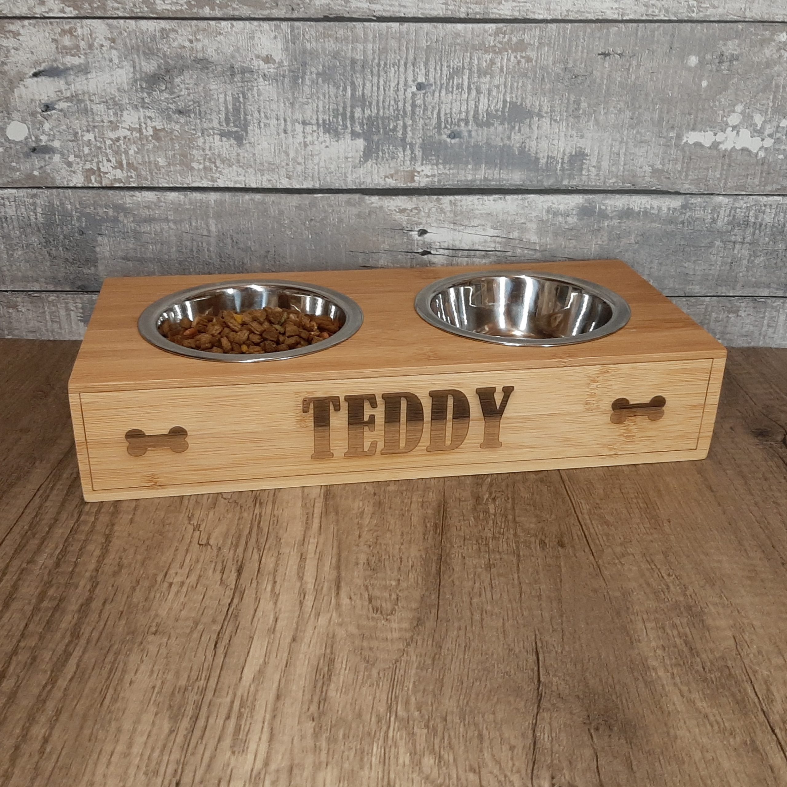 Wooden Pet Bowl Riser feeding stand for dogs with personalised name and bones design filled with food