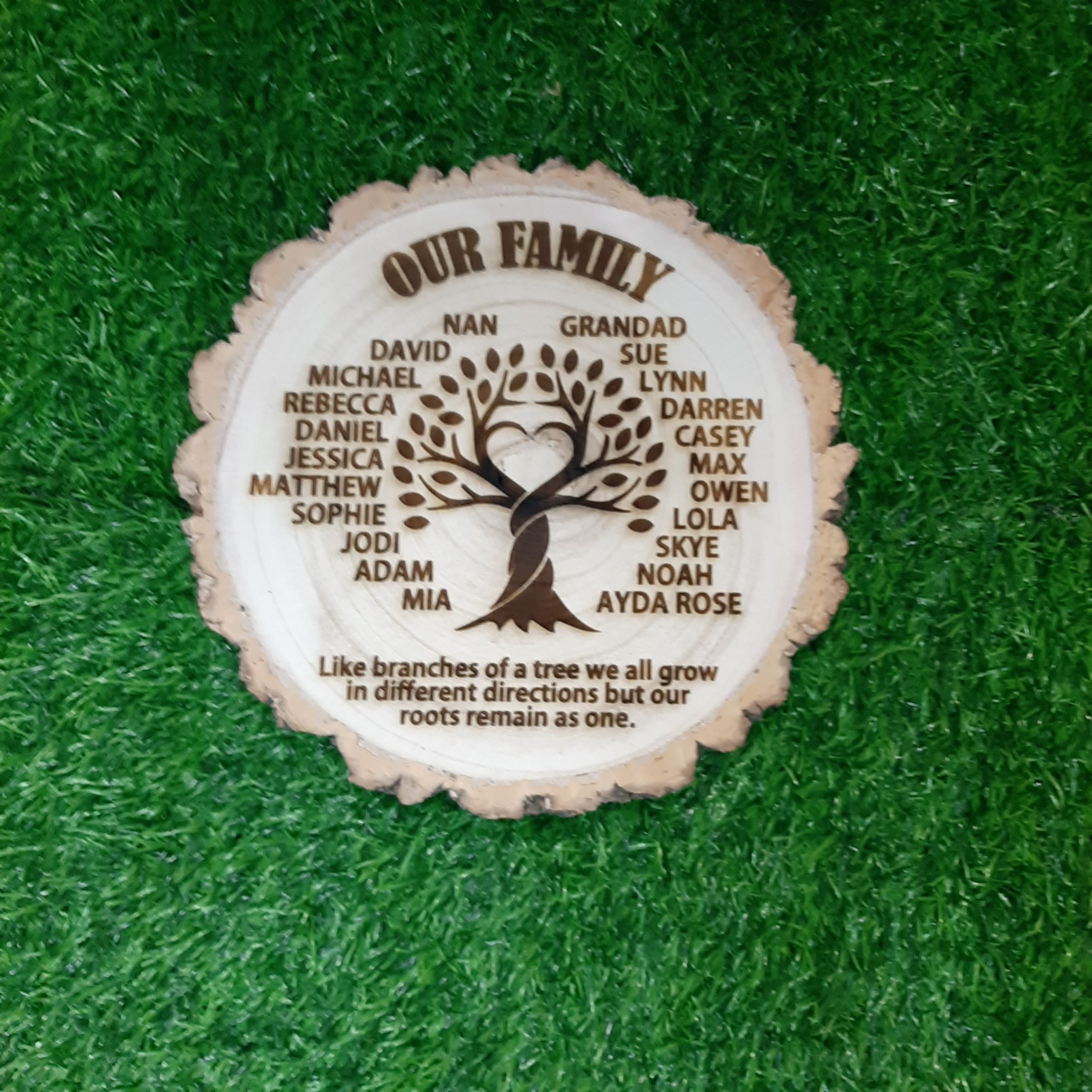 Family Tree Log Slice with engraved family tree with names with title our family and quote like branches on a tree