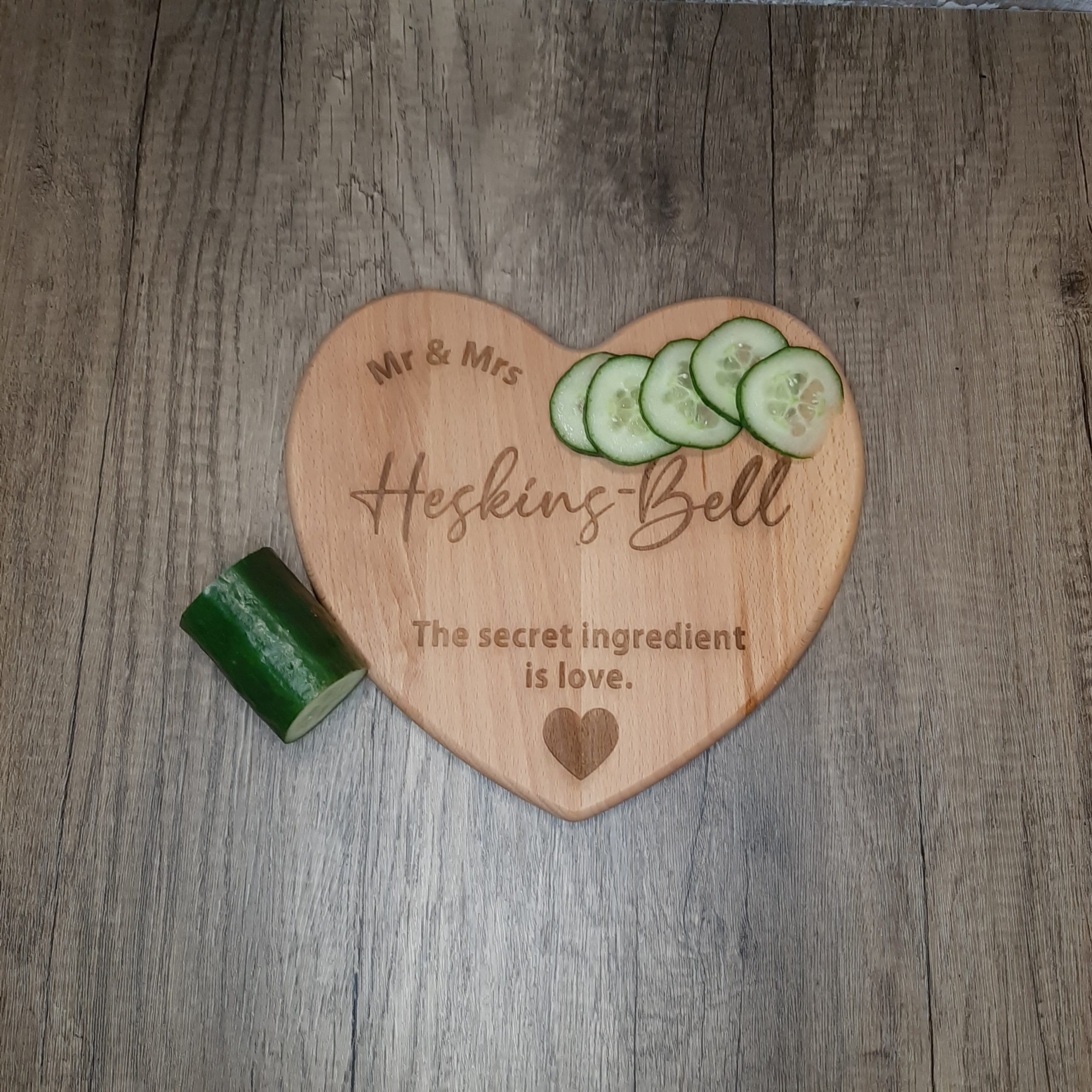 wooden heart chopping board with engraved personalisation for wedding anniversary love inscription