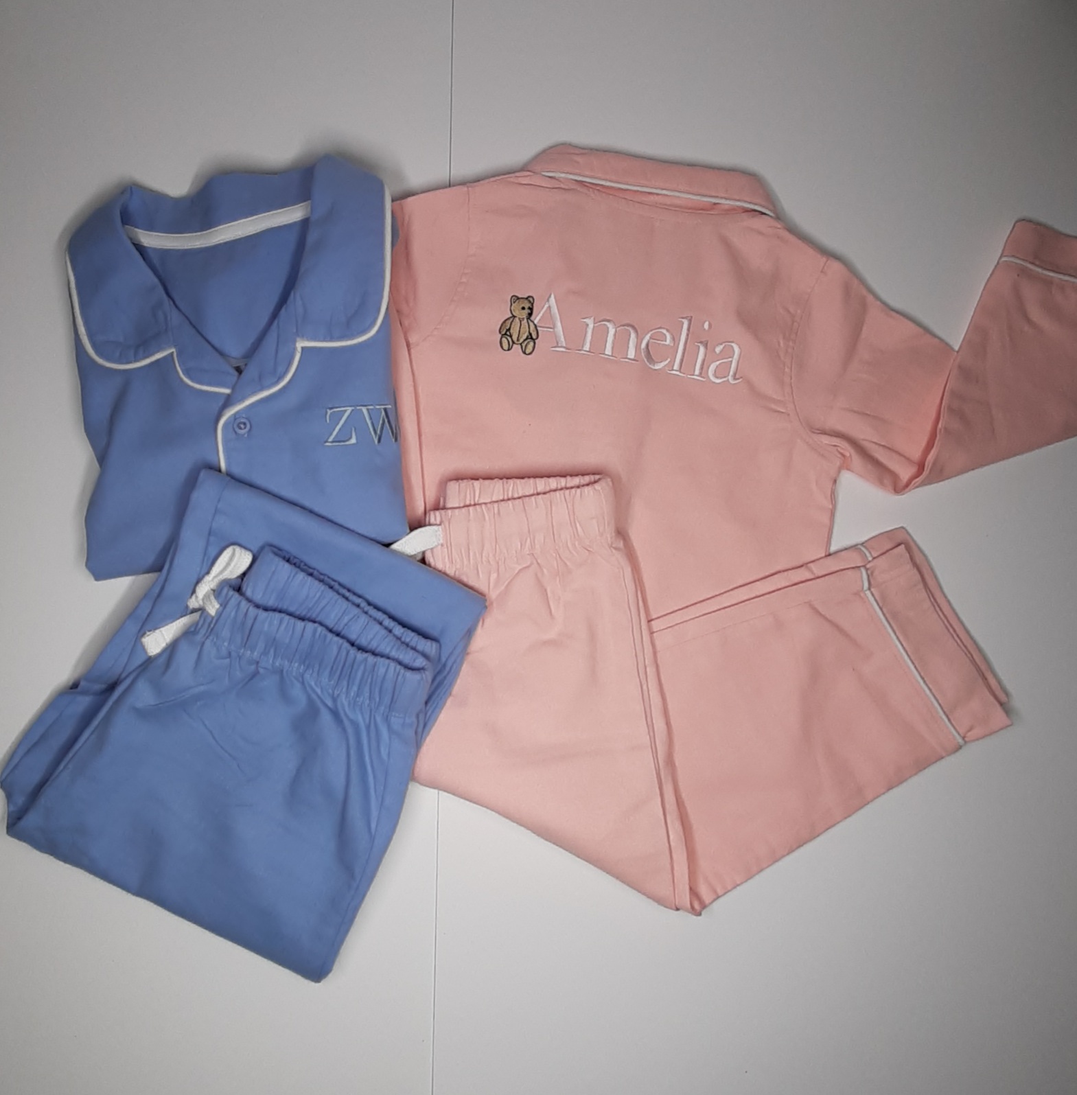 classic children's pjs in dusky pink and blue. with embroidered name and initials personalised
