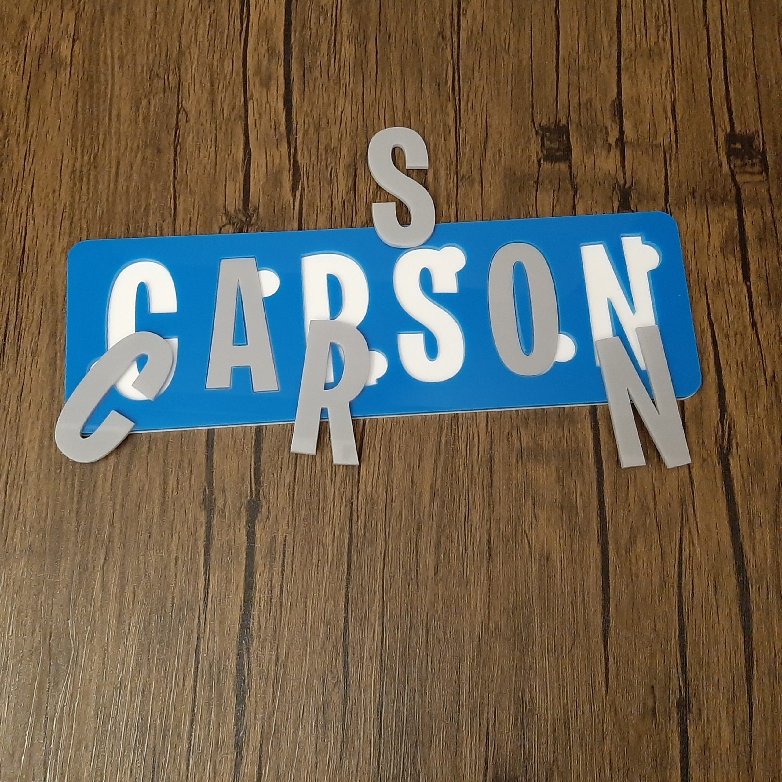 Colourful Name Puzzle in blue grey and white laid on floor