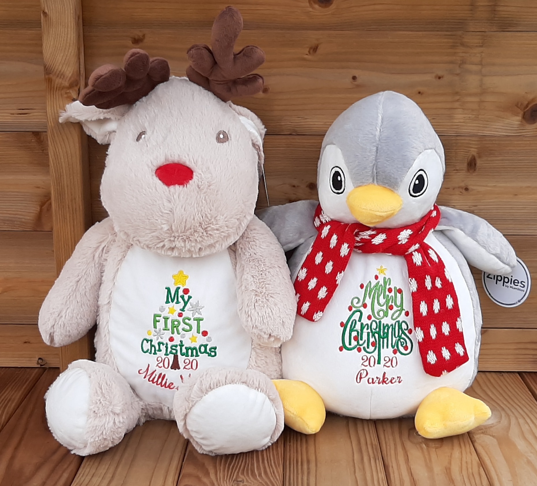 Embroidered Soft Cuddly Reindeer next to the cuddly penguin