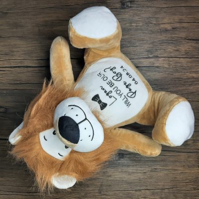 Embroidered Soft Cuddly Lion laid on the floor with page boy design