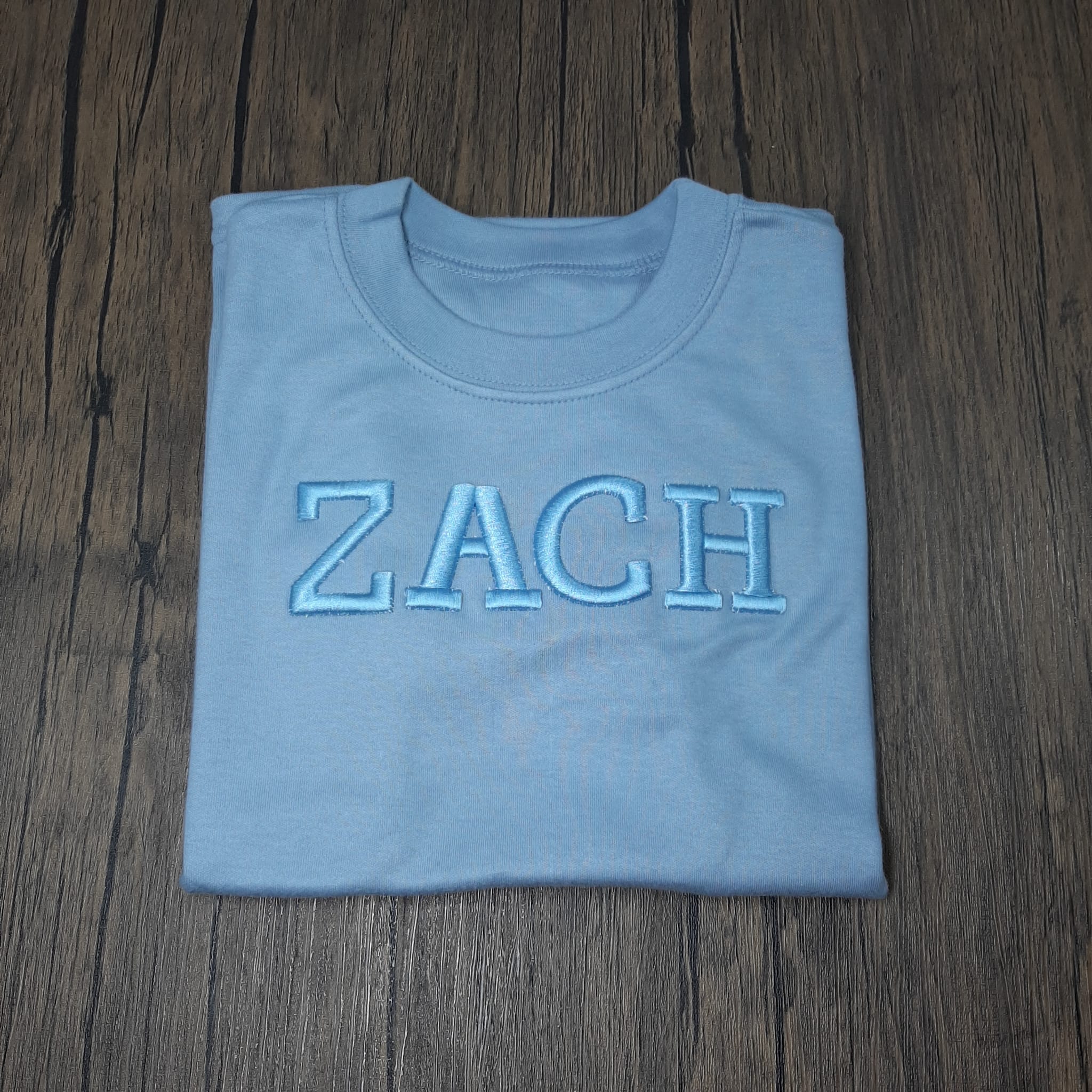 dusky blue t shirt with a 3d puff embroidered name personalised