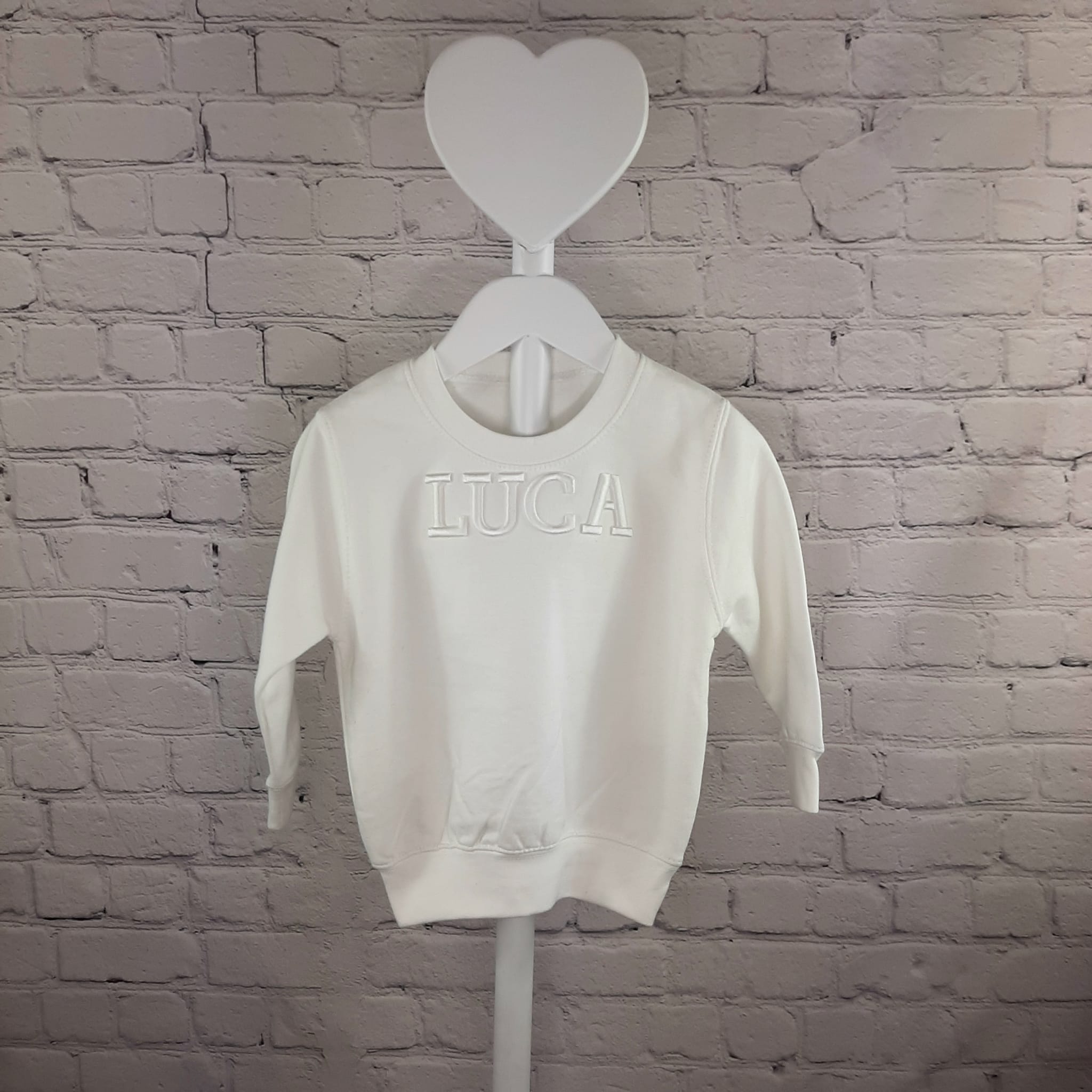 white jumper with a 3d puff embroidery personalisation on a model 3D Name Jumper/T Shirt