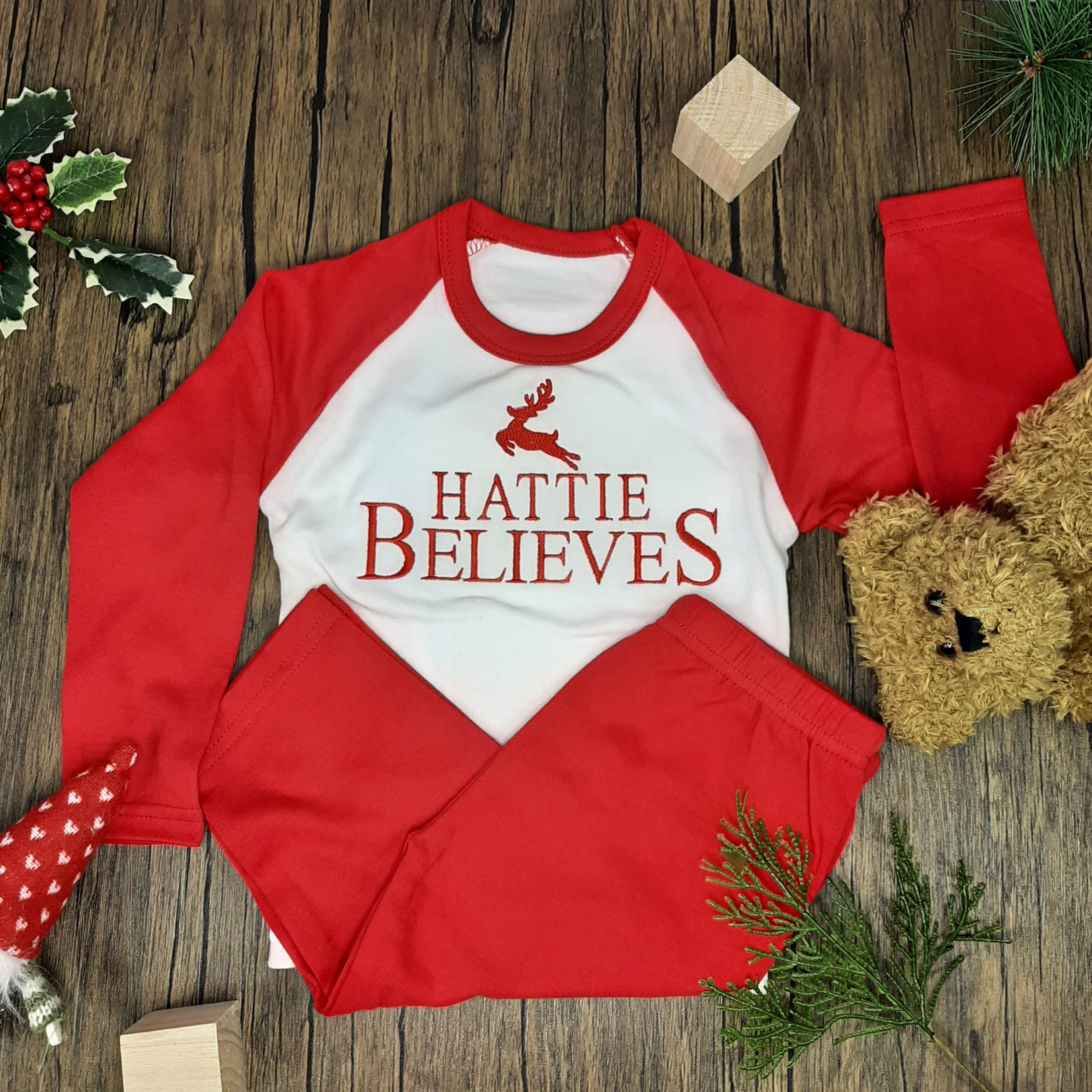 Believes Christmas PJs in red and white for christmas professionally embroidered personalisation. laid