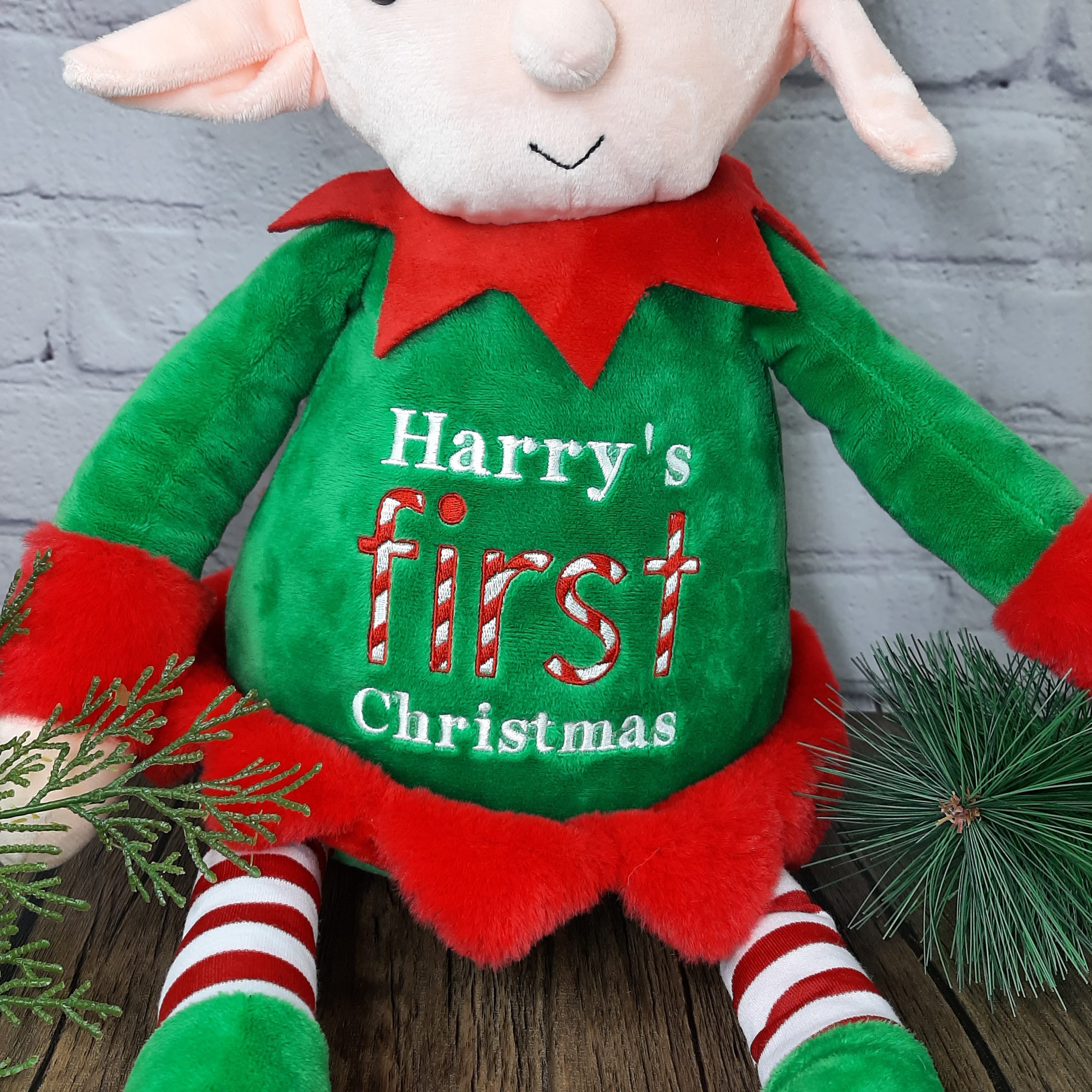 large plush elf with embroidered first christmas design and personalisation. elf on shelf. first christmas zoomed on design