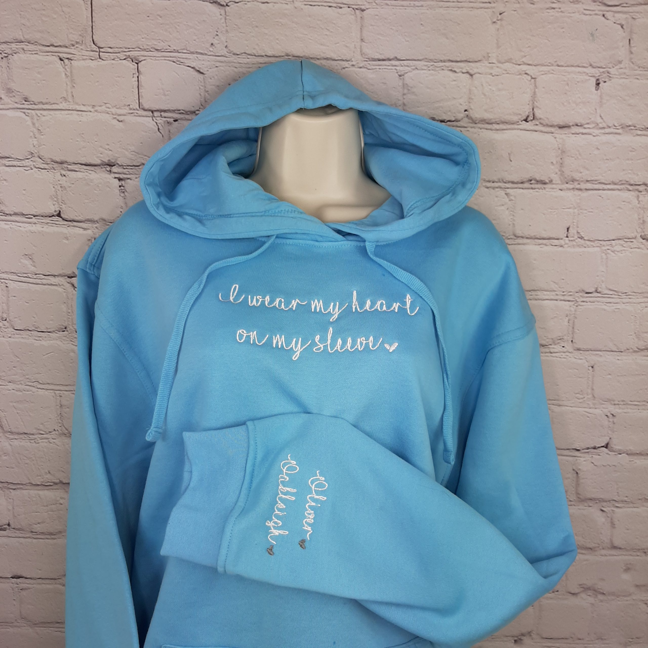 Heart on my Sleeve Hoodie, personalised mother day present of gift for mum gift for her, embroidered with names and hearts on sleeve. close up. Gift for her, gift for mum