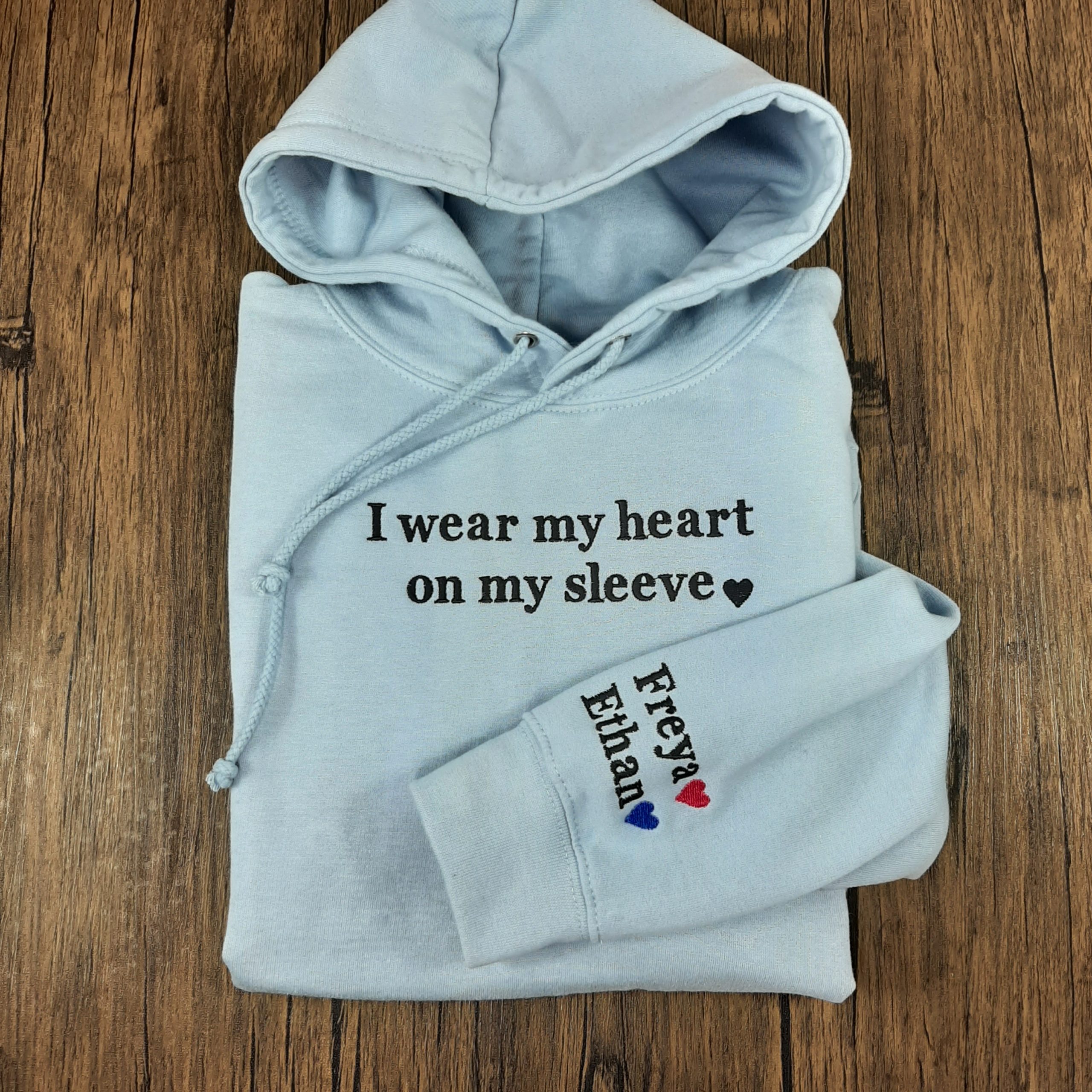 Heart on my sleeve embroidered personalised hoodie, with childrens names on the sleeve with coloured hearts, gift for her, gift for mum. Basic Font. Folded