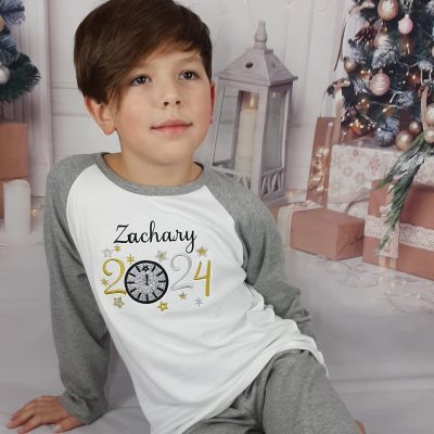 New Years Eve Sparkly Pjs embroidered personalisation with glitter modelled by a boy but suitable for a girl cropped
