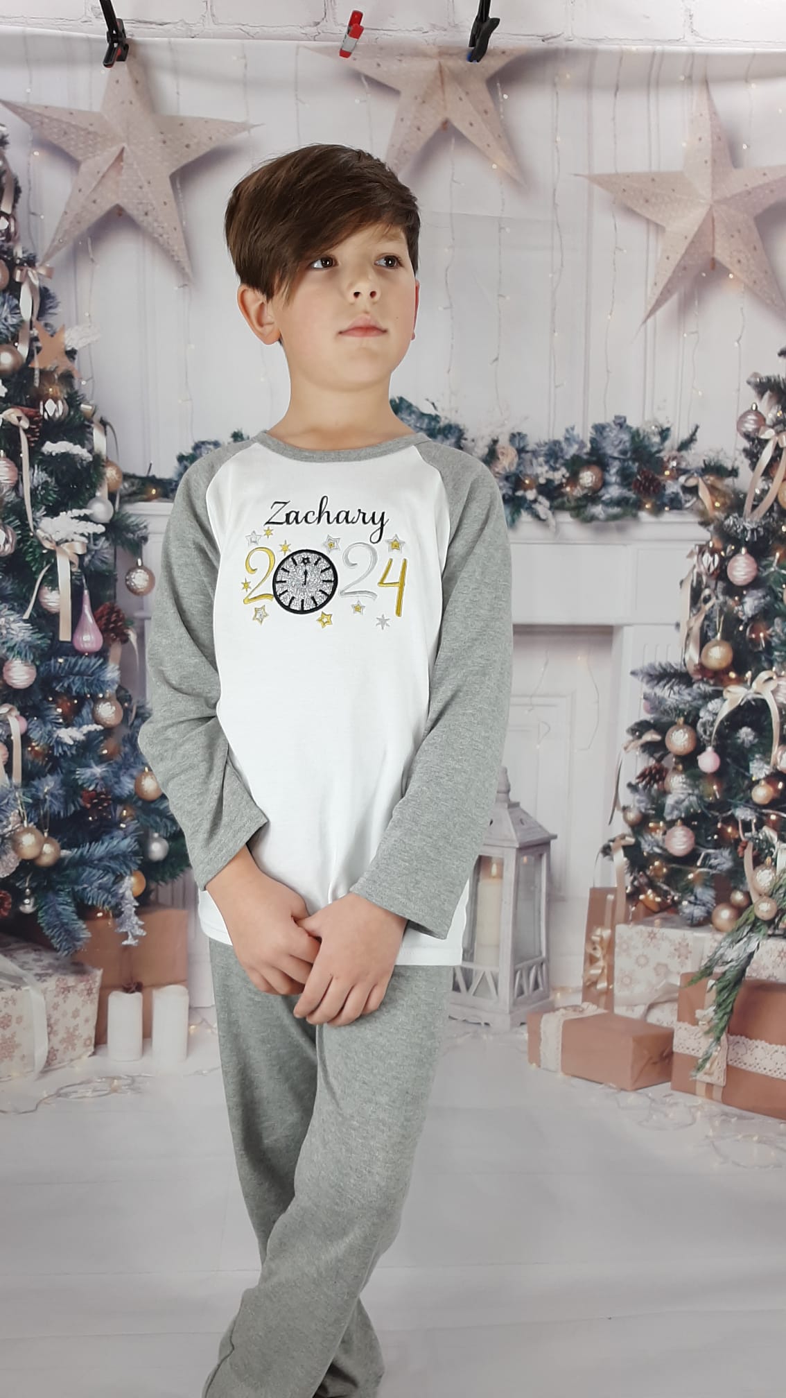 New Years Eve Sparkly Pjs embroidered personalisation with glitter modelled by a boy but suitable for a girl stood