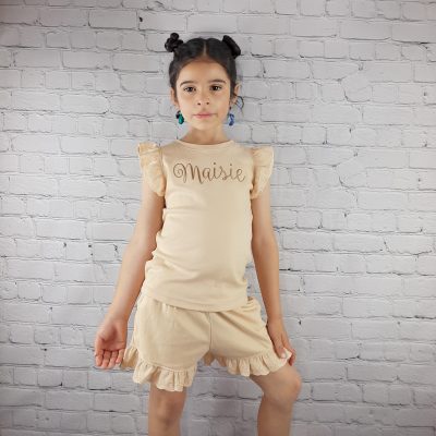 frill shorts and t-shirt set for summer personalised with embroidered name across the chest in brown thread apricot