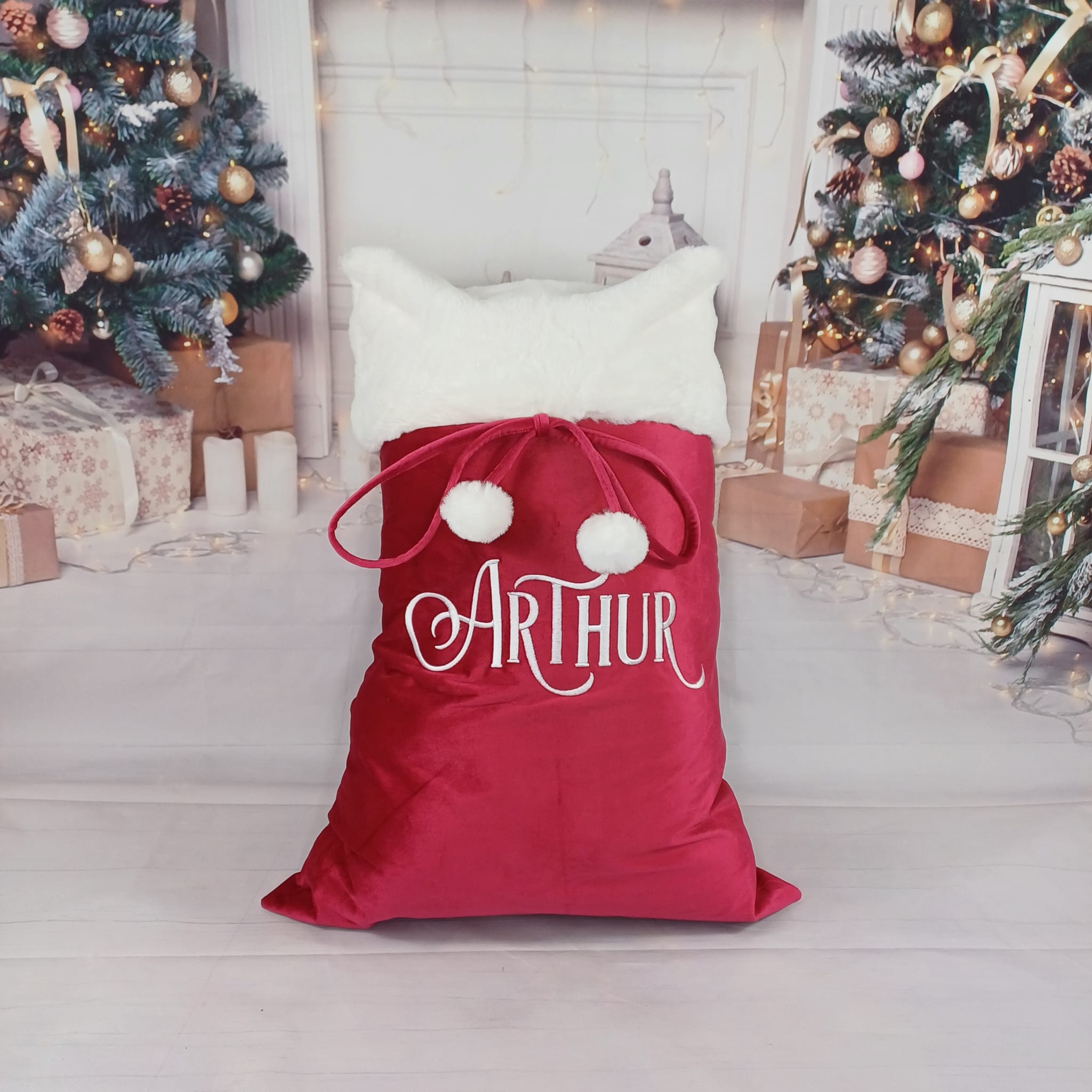 Luxury Personalised Christmas Sack in traditional red and white plush fabric, lined for durability and finished with fluffy pom poms. Generous size or stockings